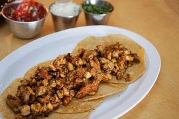 Mexican tacos with chirmol, onions and sauce.