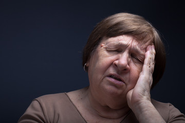 Portrait of elderly woman. Pain