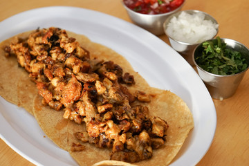 Mexican tacos with chirmol, onions and sauce.