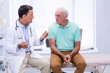 Doctor interacting with senior patient - Powered by Adobe