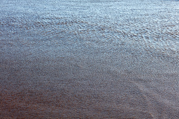 The surface of the water on the beach