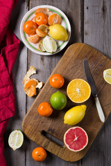 Fototapeta na wymiar various types of citrus fruit on a dark wooden background