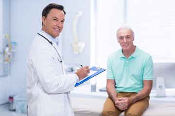 Fototapeta na wymiar Portrait of smiling doctor and senior patient