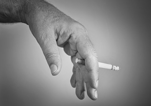 Man's hand with a cigarette black and white