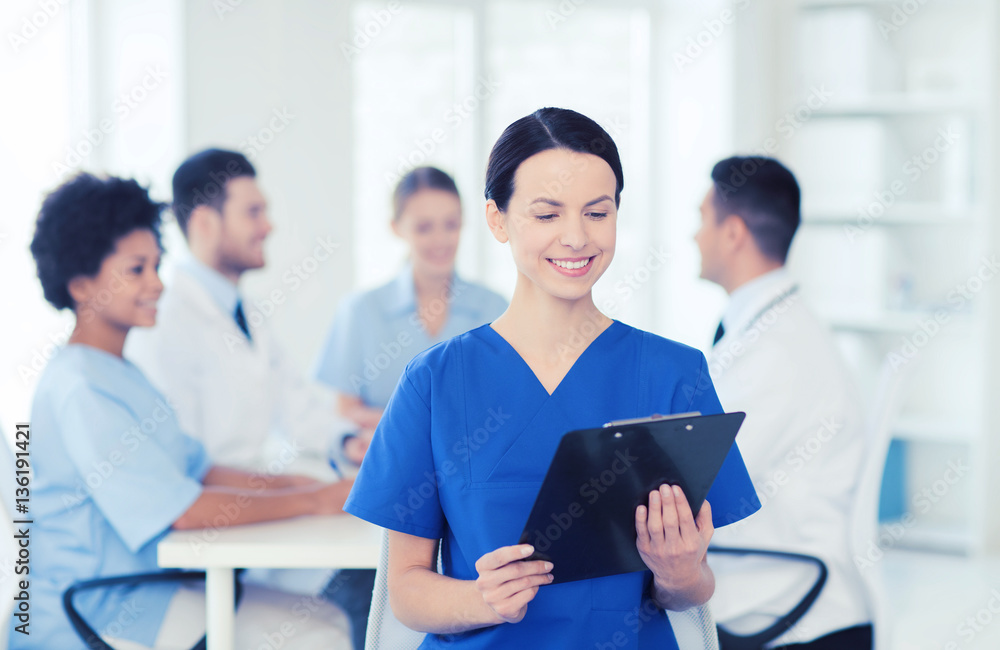 Wall mural happy doctor over group of medics at hospital