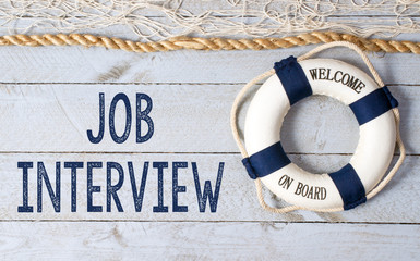 Job Interview - Welcome on Board - lifebuoy with text on wooden background