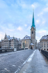 Naklejka premium Winter landscape of Zurich. Waldmann monument and Munsterbrucke bridge, Switzerland