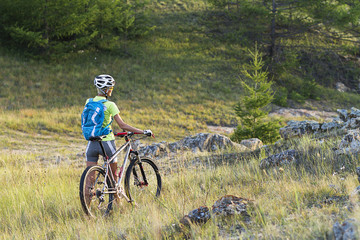 young girl on mountain bike in the mountains