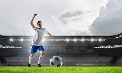 Soccer player at sport arena . Mixed media