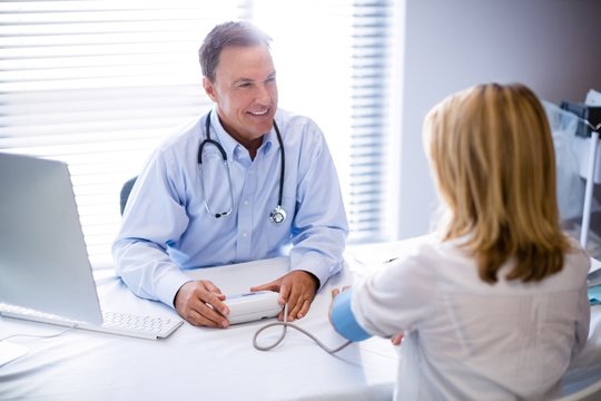 Doctor checking blood pressure of a patient
