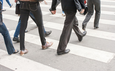 Fototapeta na wymiar legs of pedestrians in a crosswalk