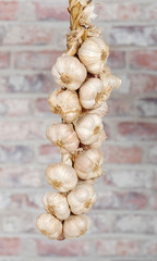 String of garlic on a brick wall