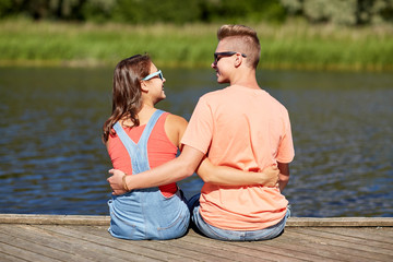 happy teenage couple hugging on river summer berth