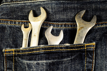Different wrenches in a pocket of the jeans