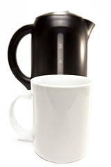 electric tea kettle on a white background and a mug
