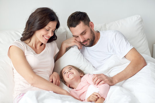 happy family in bed at home