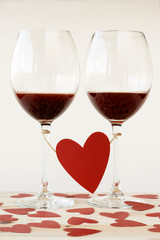 Two glasses of red wine tied with red heart. Valentines Day