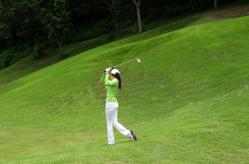 Women player golf swing shot on course in summer - Sports concept, greenery tone