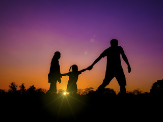 silhouette father, mother and daughter