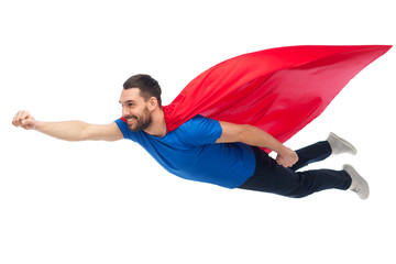 happy man in red superhero cape flying on air