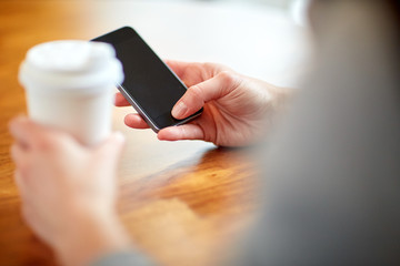 close up of woman with smartphone and coffee