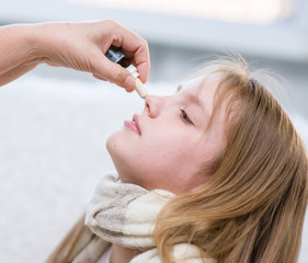 doctor medication drips into the nose girl