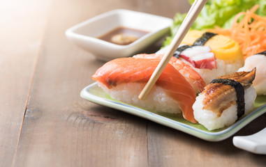 Fresh Salmon sushi on chopstick, Japaness food