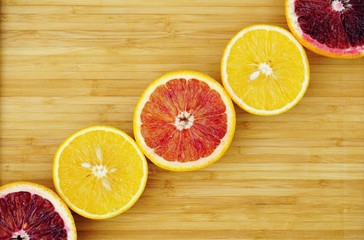 Fototapeta na wymiar Diagonal row of orange citrus cut in half on a platter