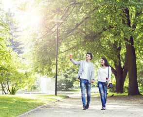 Young beautiful couple walking in the park. Love, relationship, dating: concept.