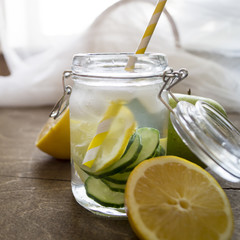 Lemon cucumber detox water on wooden background