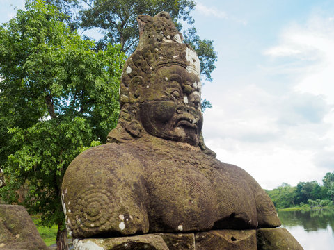 Statue of stone asura or demon at Angkor Thom, ancient capital of Khmer empire in the 12th century