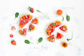 Fruit pizza made of watermelon, strawberry, apricot. Flat lay, top view