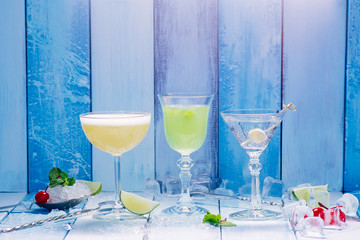 three cocktail over wooden blue background
