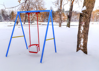 Children's playground covered with snow in winter