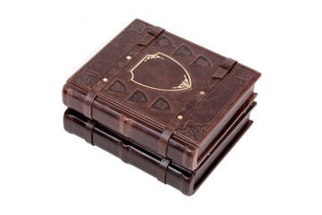 Old book in leather cover on white background