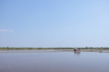 A little hut among sea salt farm.