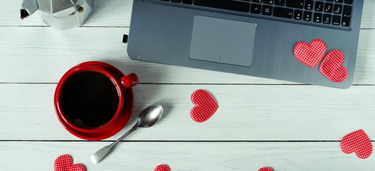 workplace for computer, coffee in a red cup and hearts . flat lay 