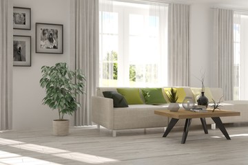 Modern interior design with sofa and green landscape in window