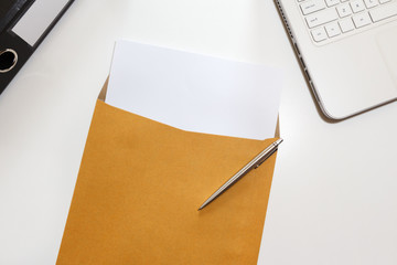 Letter in envelope with file and notebook on desk - business concept