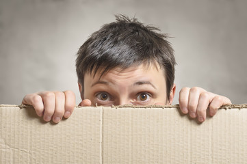 Surprised female holding empty board