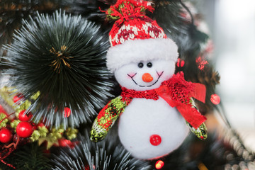 snowman on a christmas tree decorated with garland