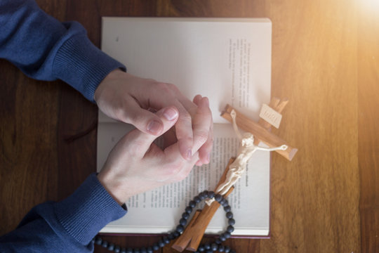 praying hands with bible