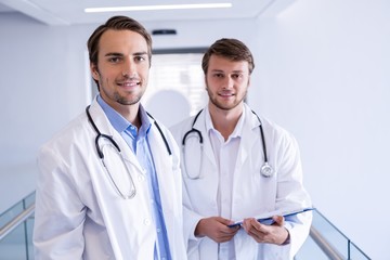 Fototapeta premium Portrait of smiling doctors standing in corridor