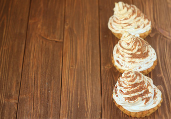  protein cake with cream and chocolate on a brown wooden table