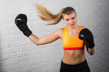 Young adult sexy boxing girl posing with gloves.