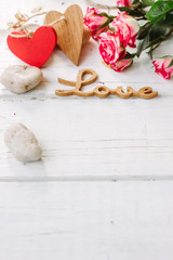wooden word LOVE with the roses and hearts - Valentines day background