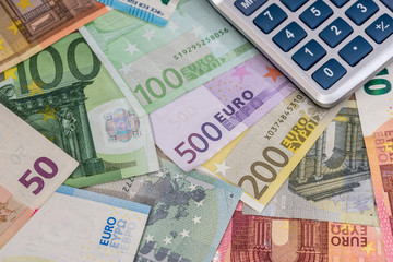 calculator above euro banknotes.