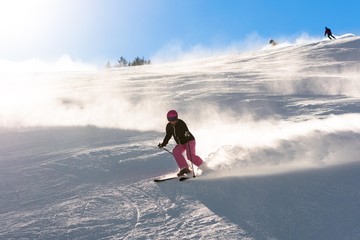 Fototapeta na wymiar Female skier in fresh powder snow and sunlight