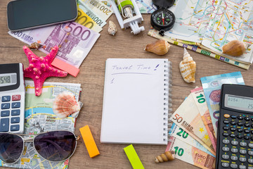Summer holiday background - notebook with selfie stick, money, glasses, map, seashells, compass.