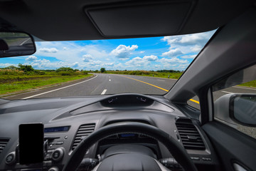 View from inside the car and drive a car on road with blue sky background, Sun light flare,...